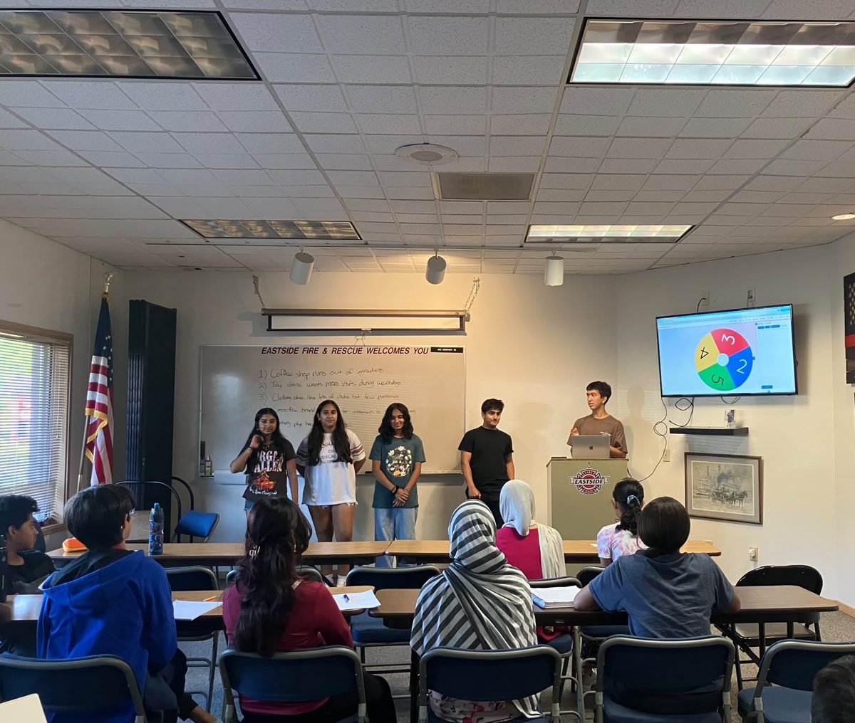 Students presenting at the front of the room