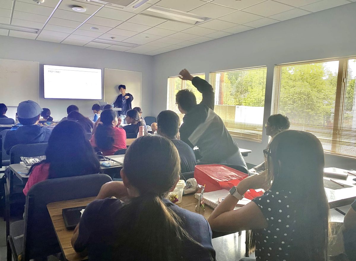 A student raising a hand during prep time